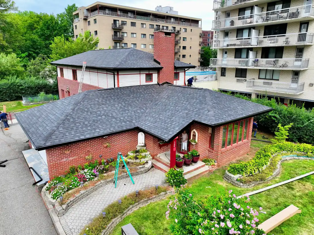 Aerial view of a new shingle roof on a brick home